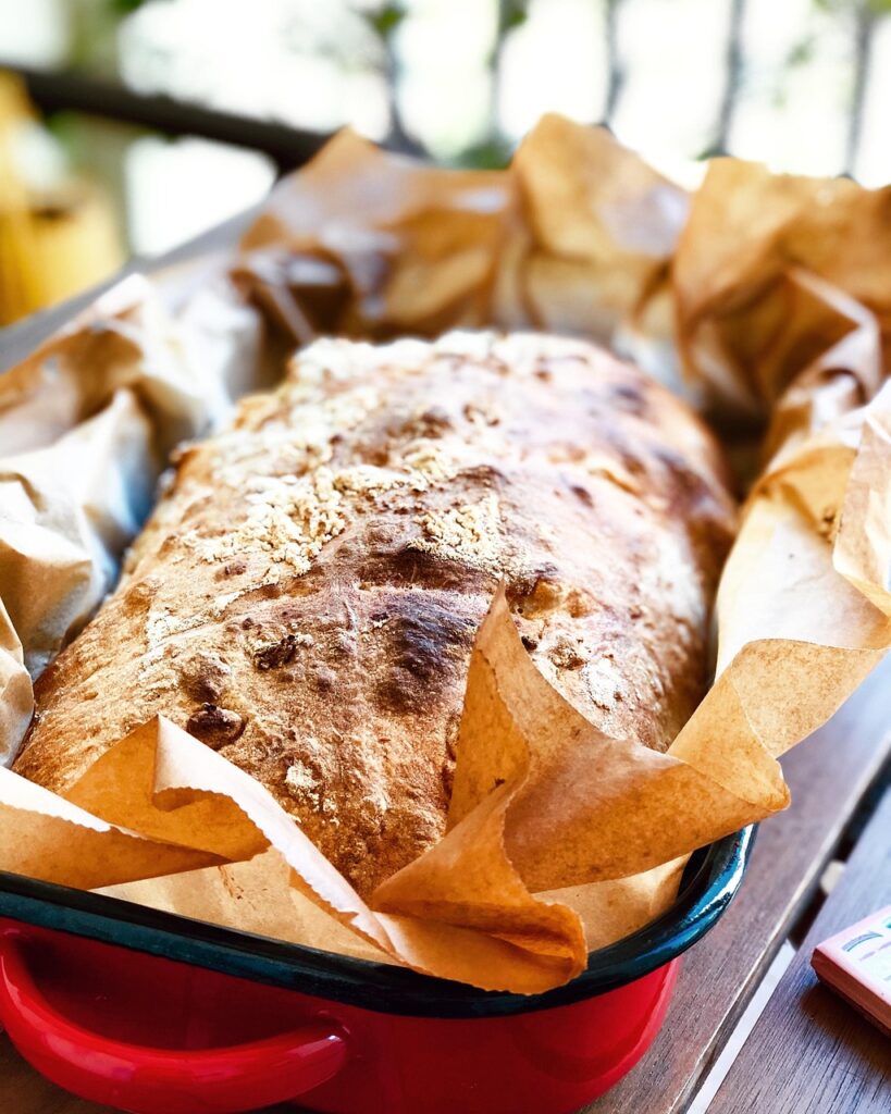 Loaf of fresh milled flour bread in a baking pan