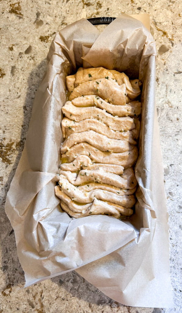 Shaped garlic pull apart bread made with ancient grains and layered with garlic butter before baking